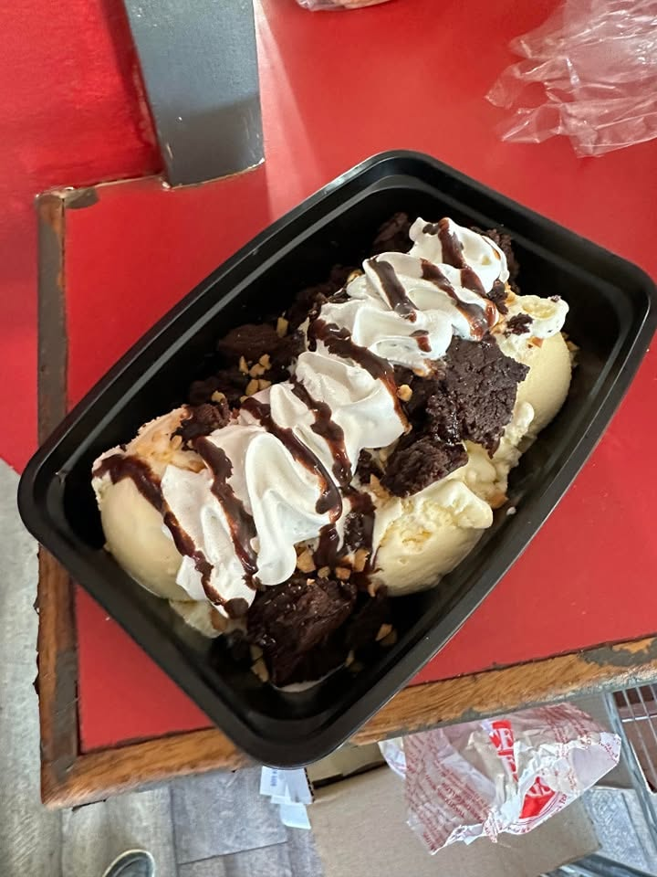 Warm brownie sundae with vanilla ice cream, whipped cream and chocolate sauce